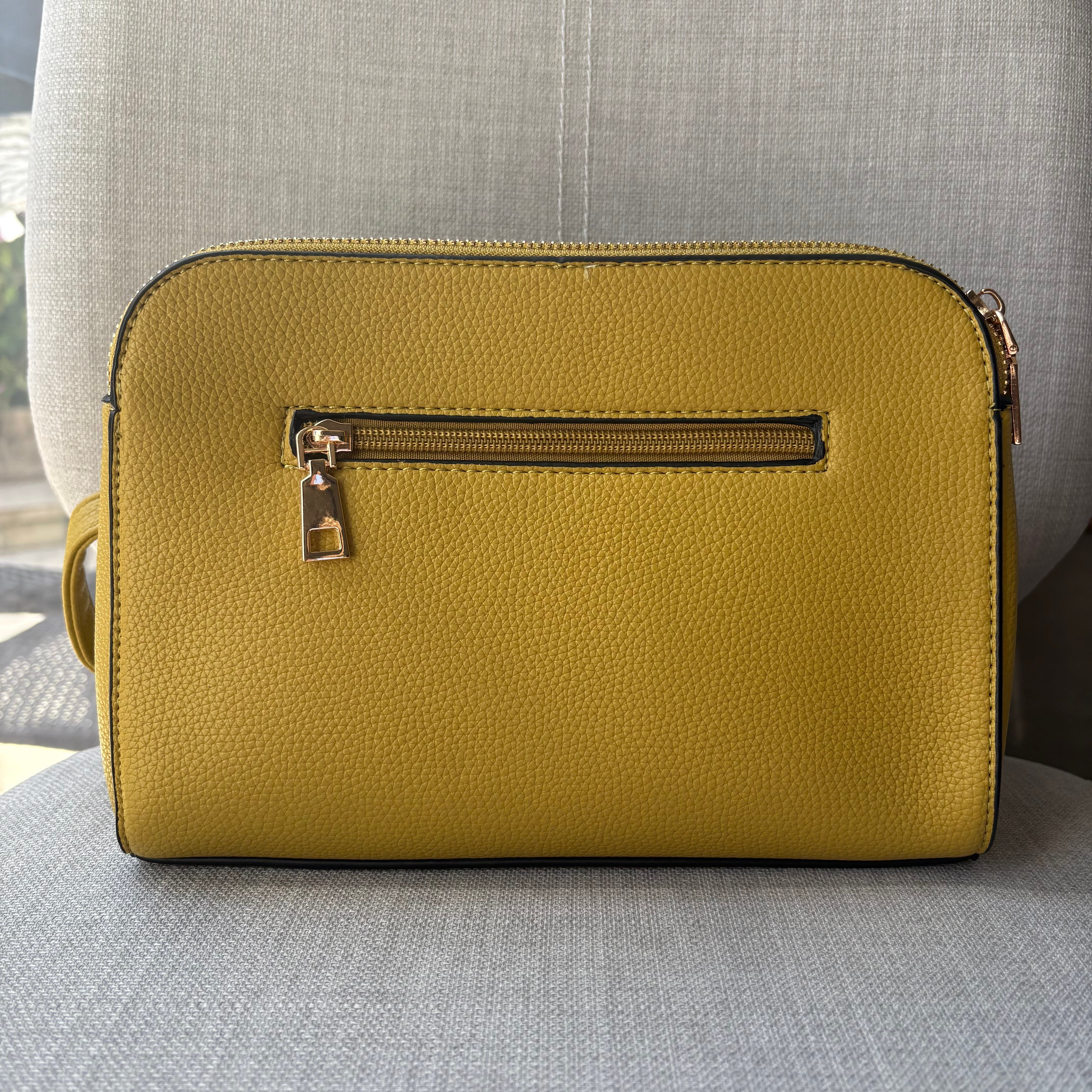 Two ring drop, three pocket crossbody bag - with matching shoulder strap - made from recycled materials