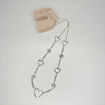 Long silver necklace, with battered metal heart stations