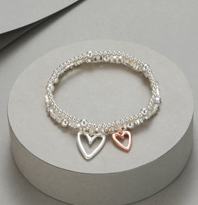 Elasticated bracelet in silver & gold, with two-row heart pendant