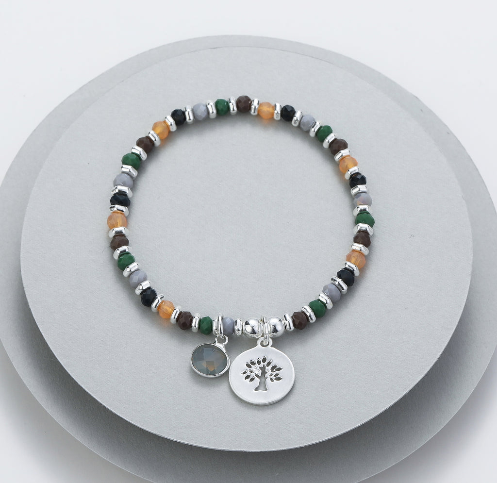 Elasticated bracelet in silver, green & earthy tones, with tree pendant