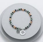Elasticated bracelet in silver, green & earthy tones, with tree pendant
