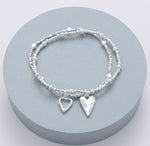 Elasticated bracelet in silver, with two-row open & solid heart pendant
