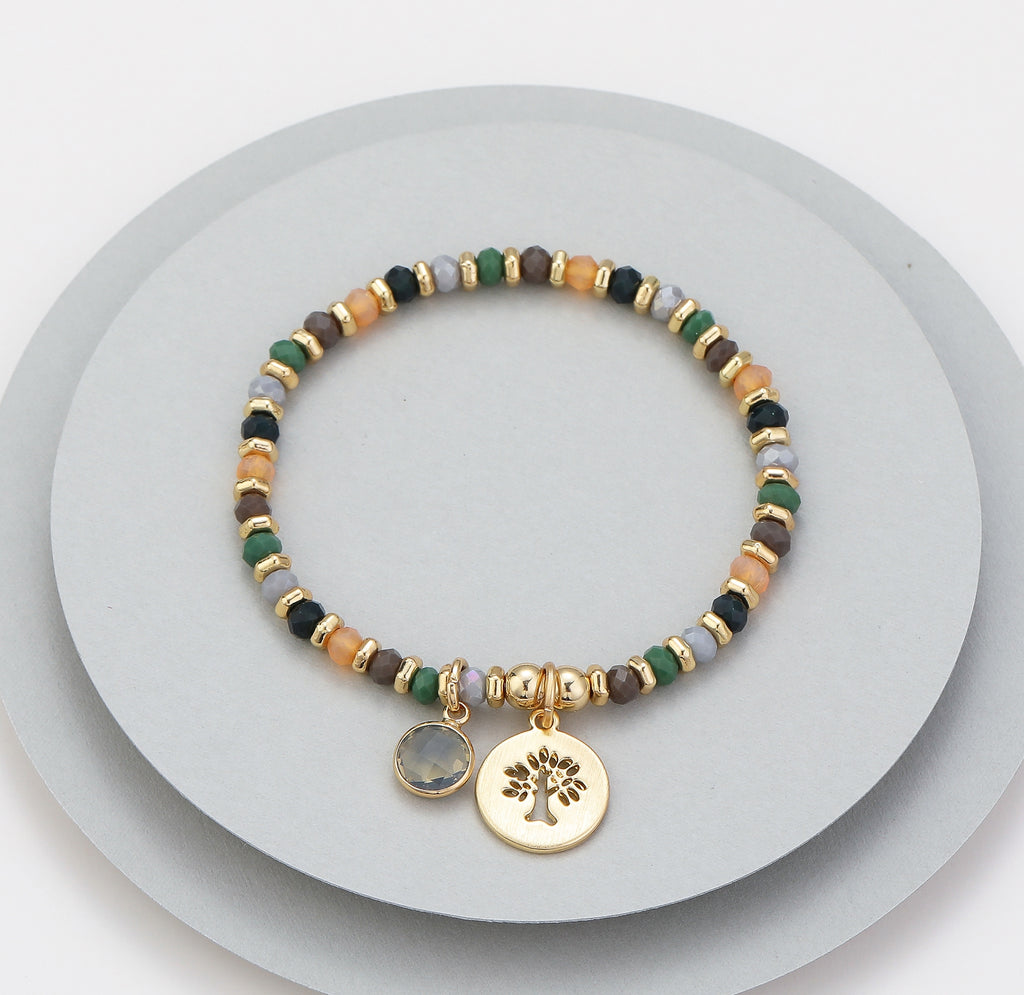 Elasticated bracelet in gold, green & earthy tones, with tree pendant