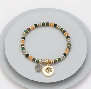 Elasticated bracelet in gold, green & earthy tones, with tree pendant
