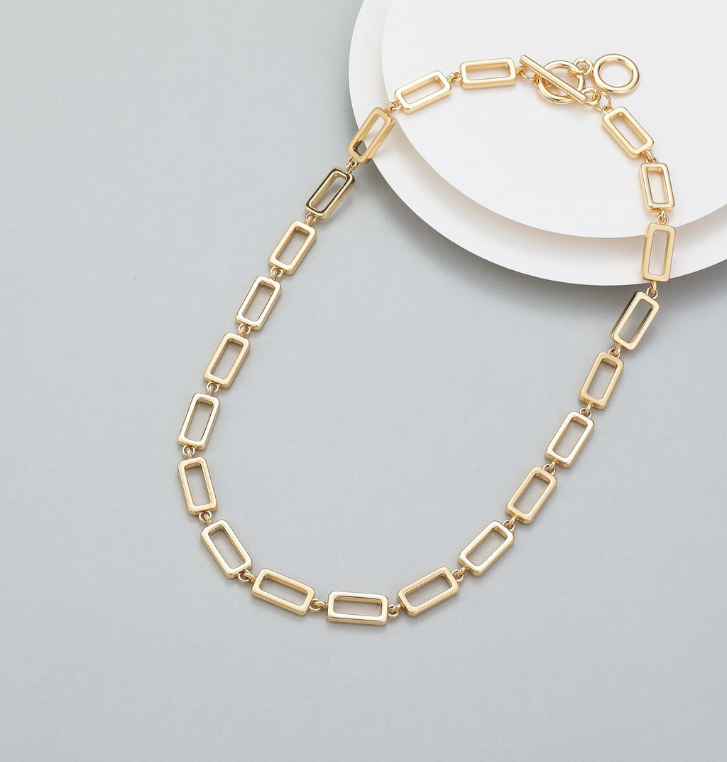 Short t-bar fastener necklace in gold, with rectangular stations