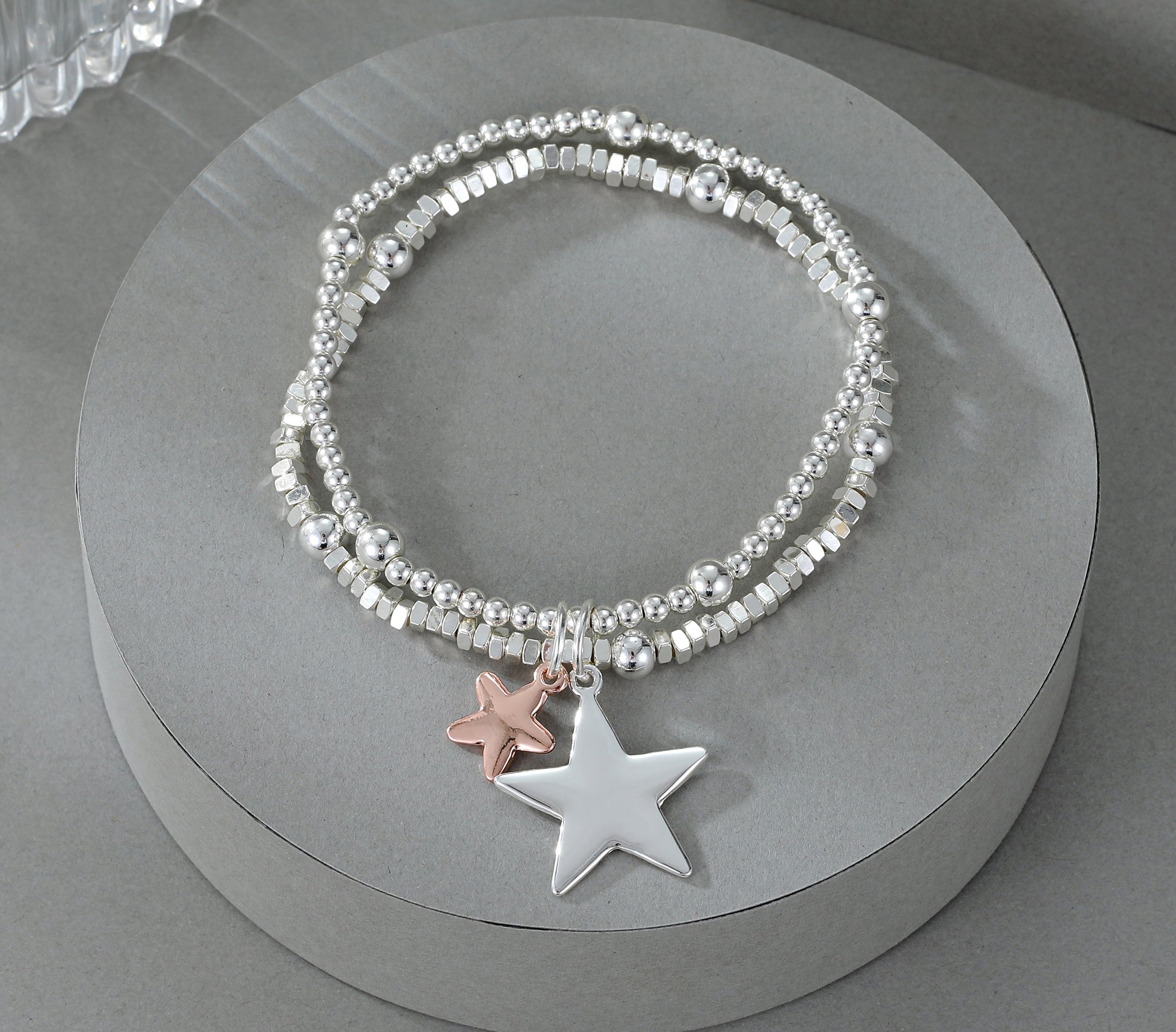 Elasticated bracelet in silver & gold, with two-row star pendant