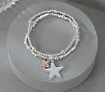 Elasticated bracelet in silver & gold, with two-row star pendant