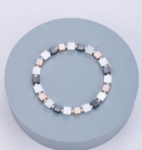 Elasticated bracelet in silver, pewter and gold with square stations