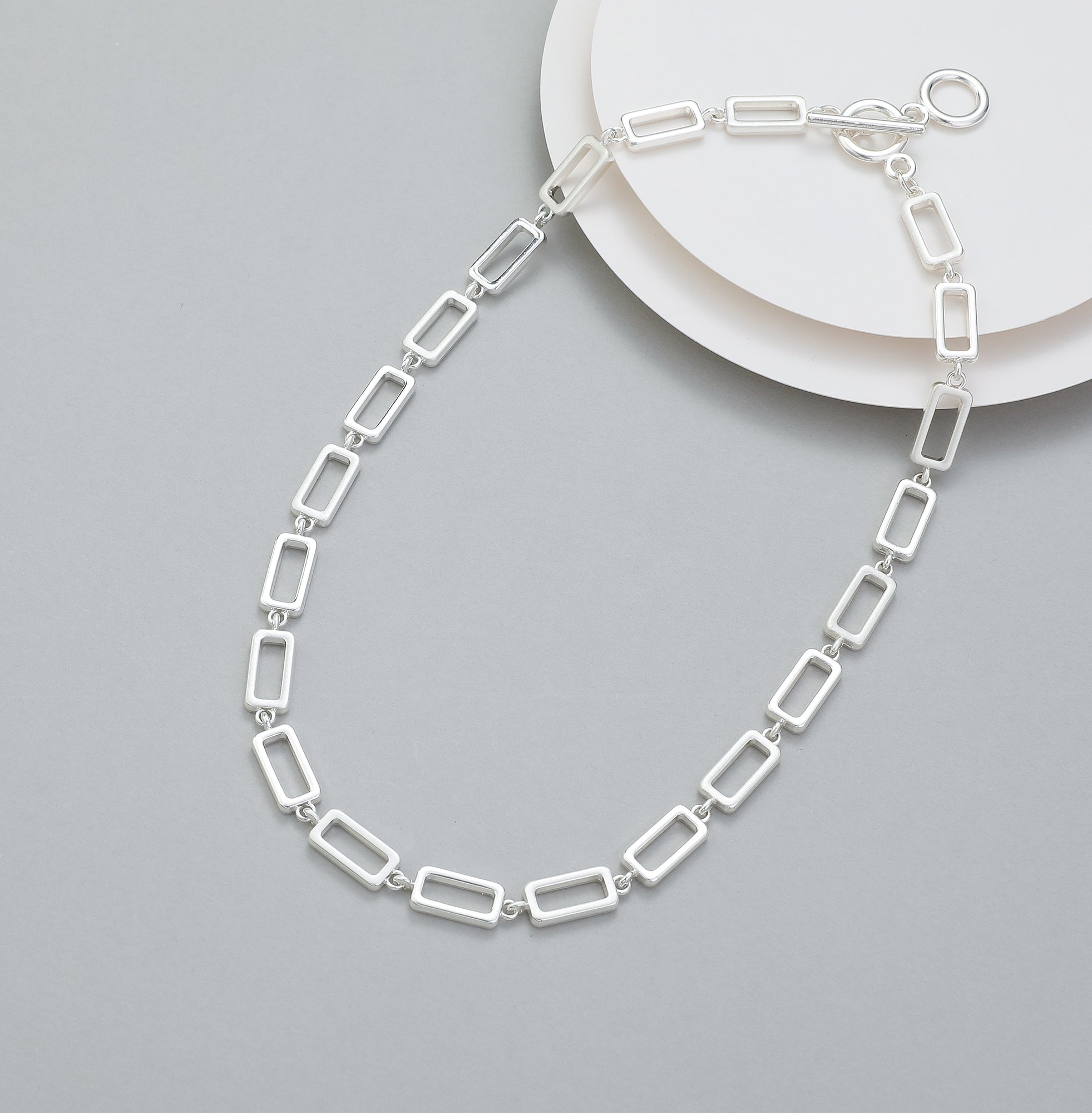 Short t-bar fastener necklace in silver, with rectangular stations