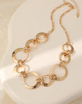 Short necklace, with gold battered metal circular links