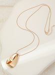 Long gold necklace, with knot design pendant