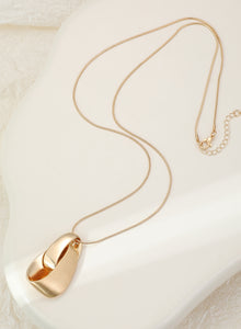 Long gold necklace, with knot design pendant
