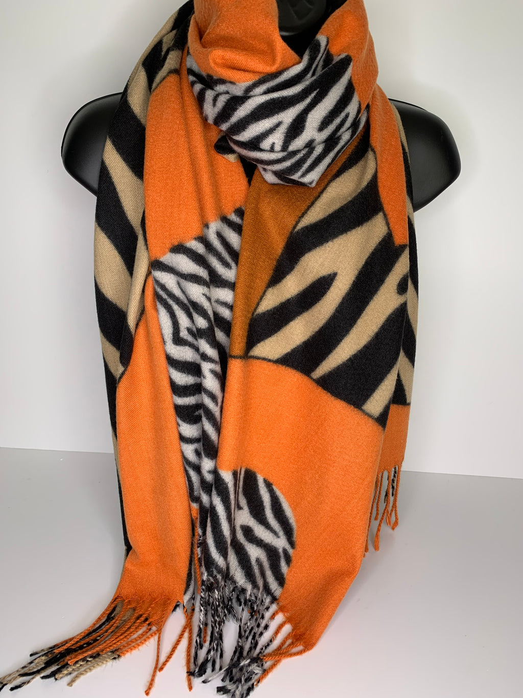 Cashmere feel orange, black, white and cream zebra print scarf