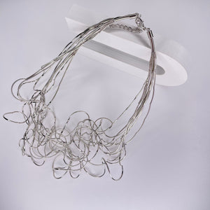 Short necklace, with ‘spaghetti’ type twists in silver, with extension chain